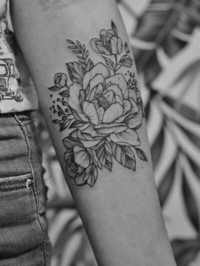 Mulher com tatuagem delicada no braço em estúdio de tatuagem em São Paulo